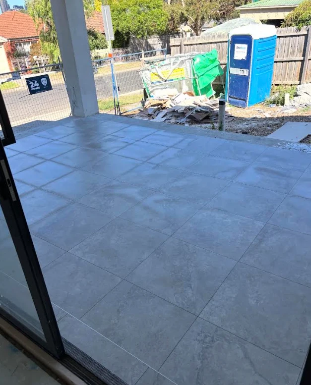Alfresco area tiled in large-format grey stone-look outdoor tiles